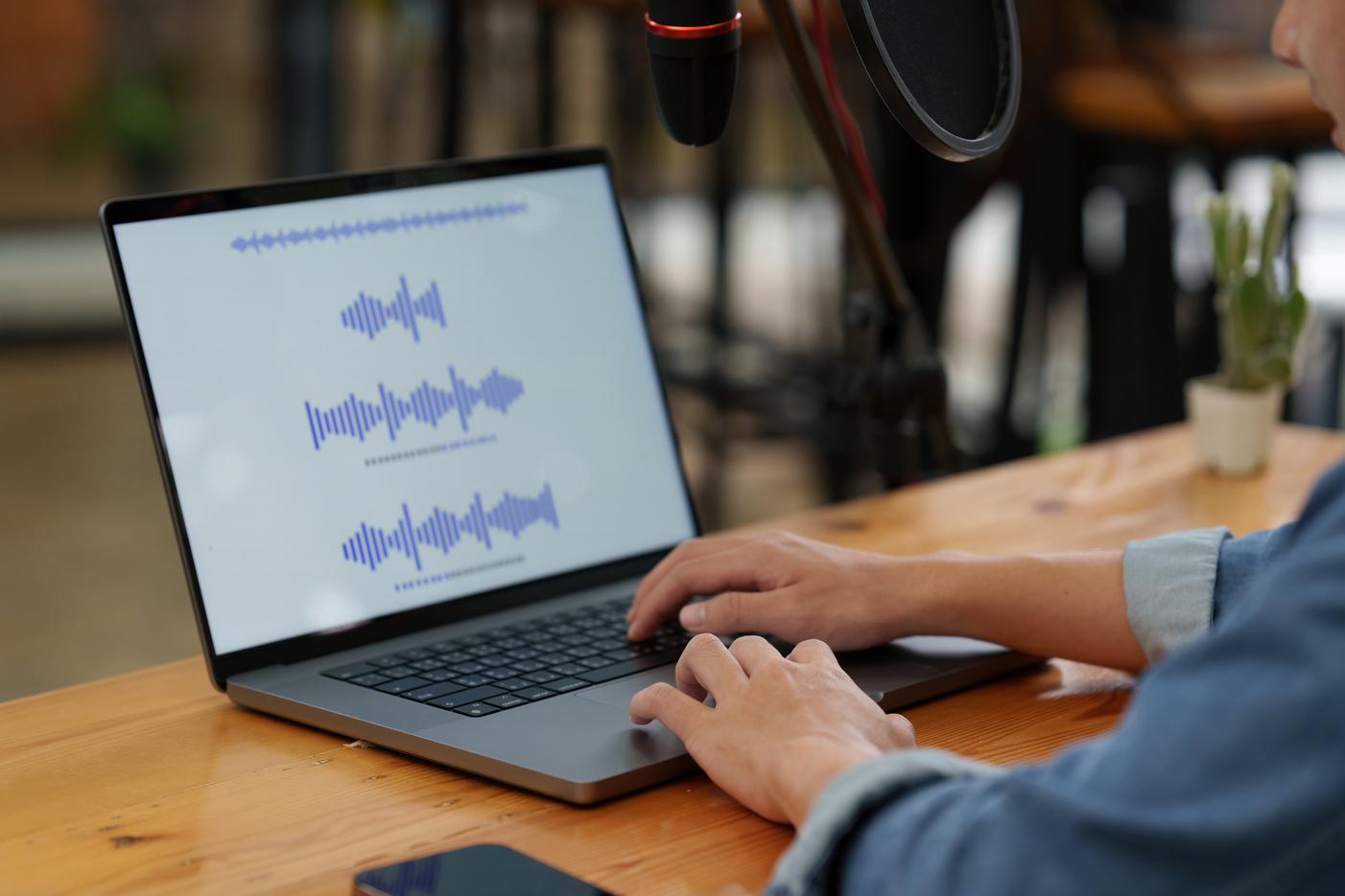 Asian podcaster editing audio podcast working at home studio
